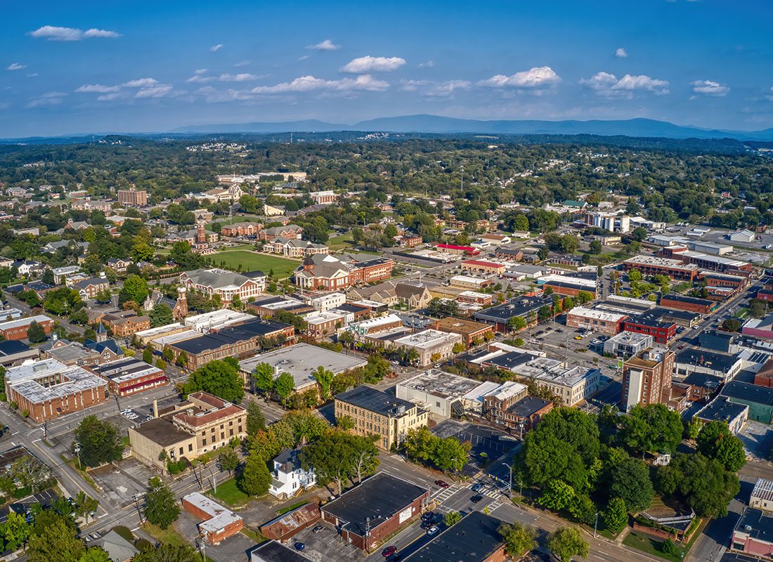 Cleveland, TN - Aerial View of Cleveland, TN Displaying Buildings and Green Trees on a Sunny Day