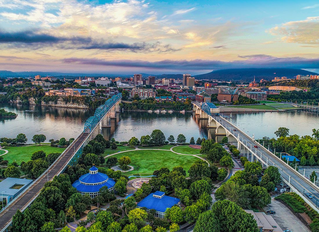 Contact - Aerial View Two Bridges Crossing a River With Green Trees